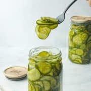 A fork serving up Quick Bread and Butter Pickles with a stone backdrop.